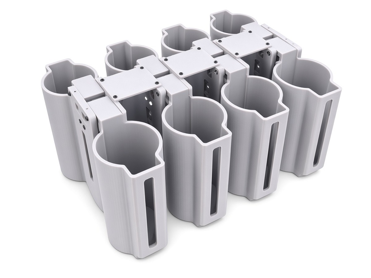 FlySpark M18SD8 8-channel smoke-canister drone dropper, empty, two rows of holder cups on a central latch spine