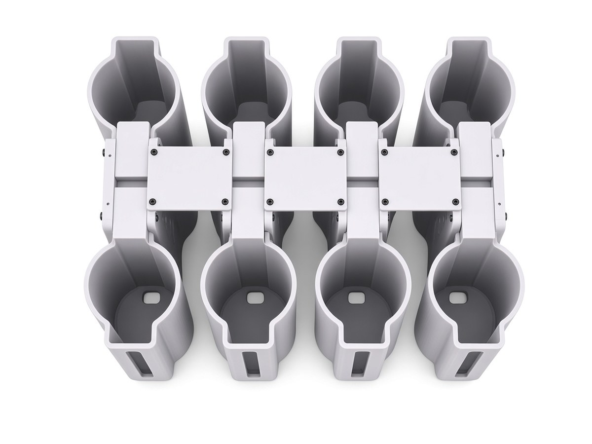 FlySpark M18SD8 smoke-canister dropper top view showing eight holder cups either side of the latch spine