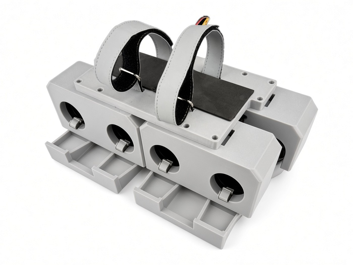 FlySpark PWD parallel-latch multi-channel drone dropper, studio view with empty payload bays, top mounting plate and straps