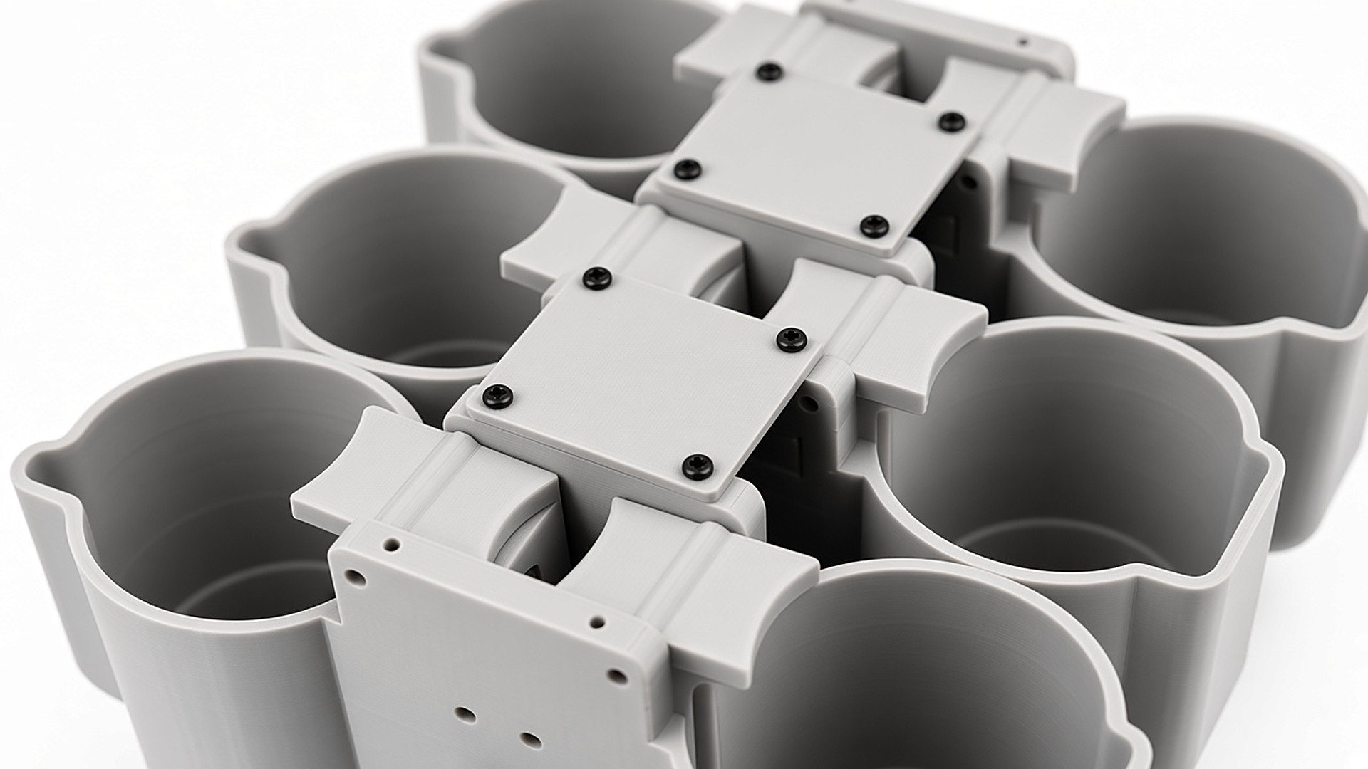 FlySpark SDC6 multi-channel drone dropper close-up of the central dual-lock spine, latch arms and cup cradles – dual safety lock on every payload position