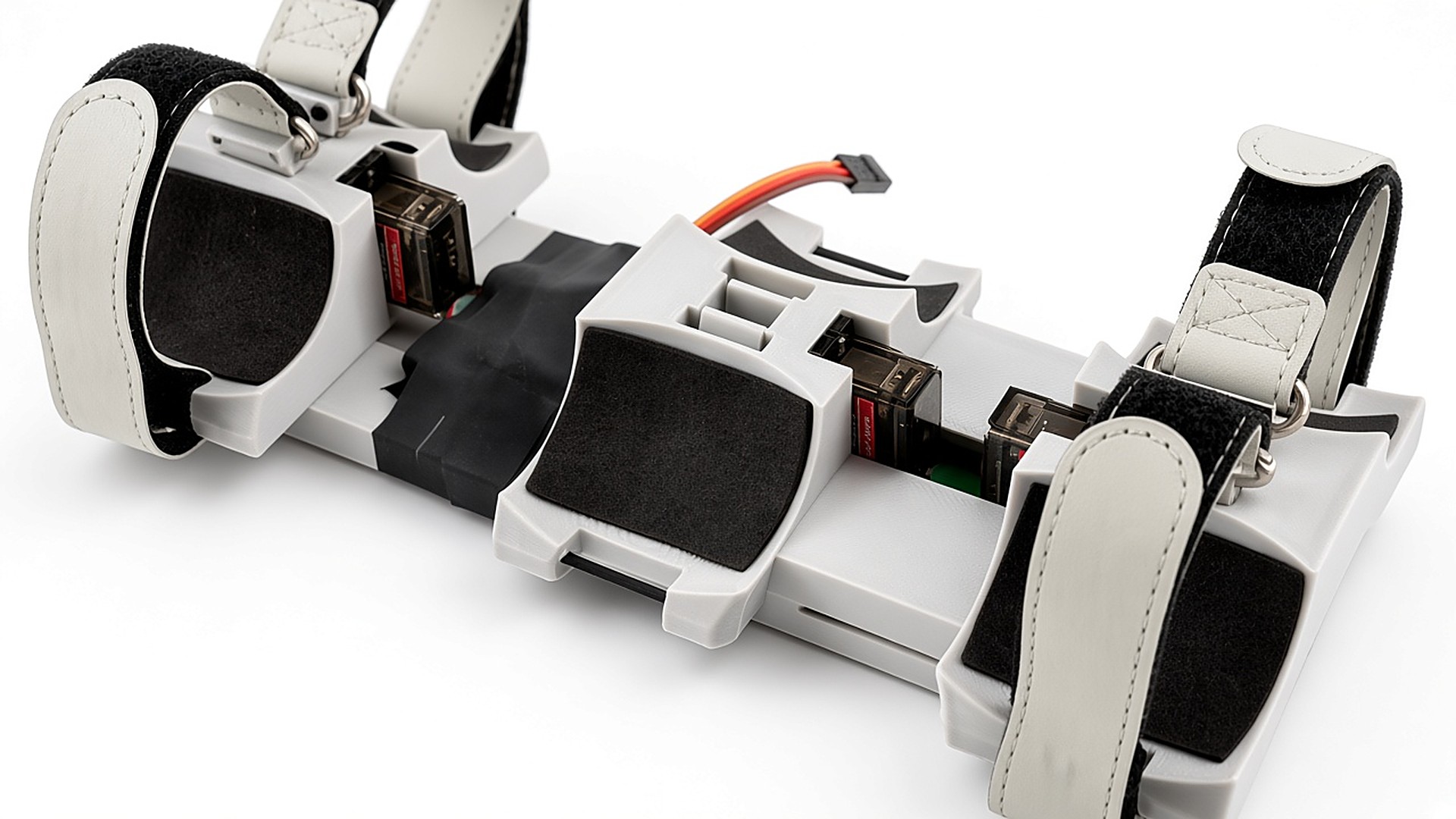 FlySpark ZD6 6-channel drone payload dropper close-up of the centre cradle, release latch block and servo-driven station latches